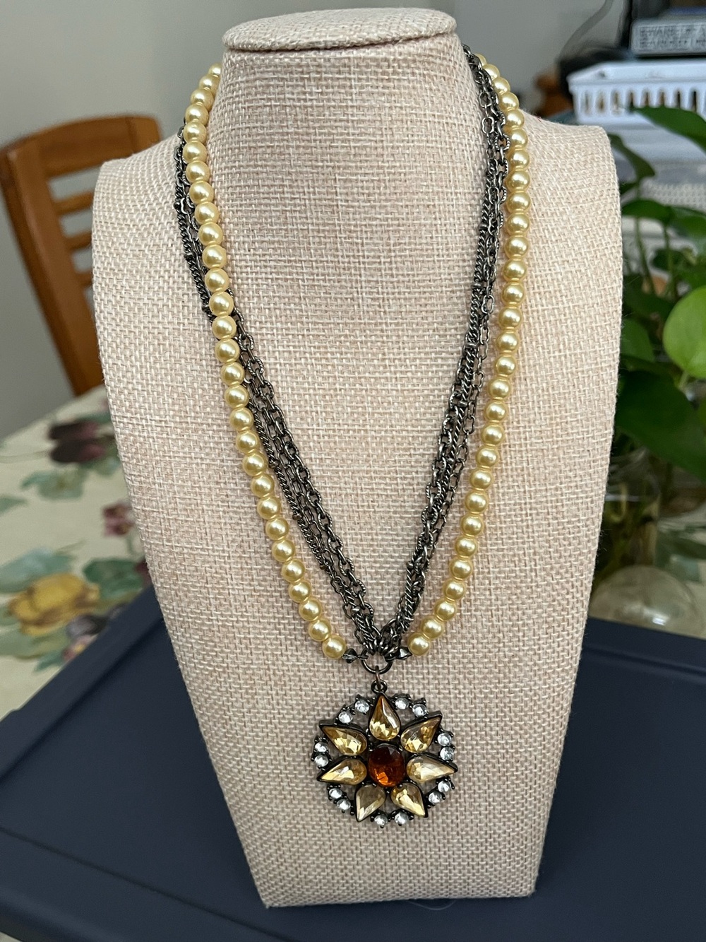 Sun style pendant on pearl/metal chain